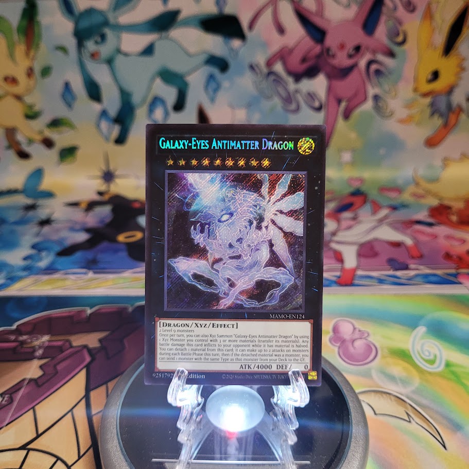 A Secret Rare "Galaxy-Eyes Antimatter Dragon" card from the Yugioh Set: Magnificent Monsters (MAMO).