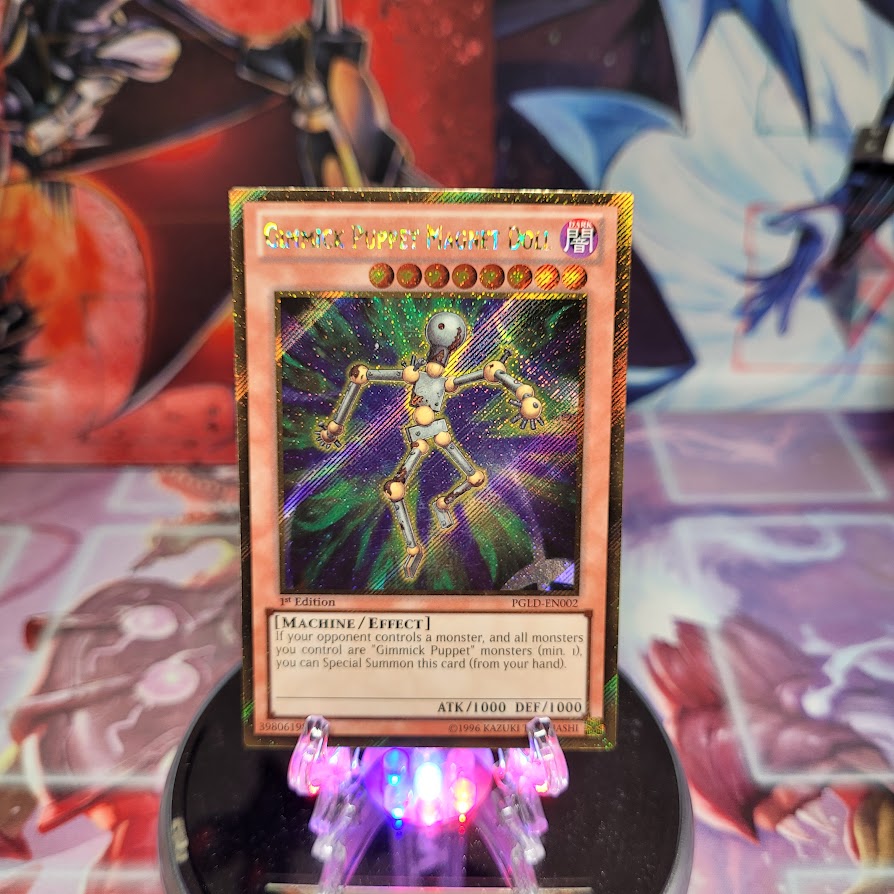 A Gold Secret Rare "Gimmick Puppet Magnet Doll" card from the Yugioh Set: Premium Gold (PGLD).