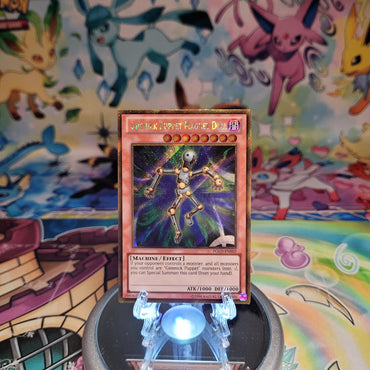 A Gold Secret Rare "Gimmick Puppet Magnet Doll" card from the Yugioh Set: Premium Gold (PGLD).