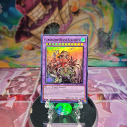 A Super Rare "Gladiator Beast Claudius" card from the Yugioh Set: Supreme Darkness (SUDA).
