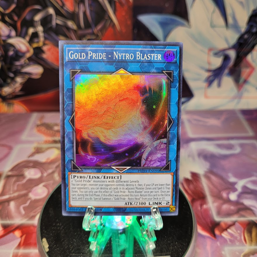 A Super Rare "Gold Pride - Nytro Blaster" card from the Yugioh Set: Photon Hypernova.