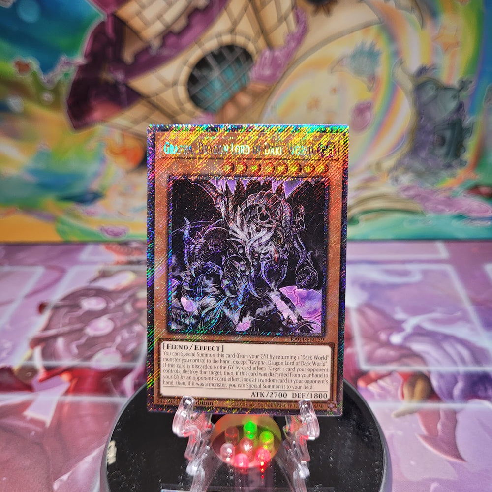 A Platinum Secret Rare "Grapha, Dragon Lord of Dark World" card from the Yugioh Set: Quarter Century Stampede (RA04).