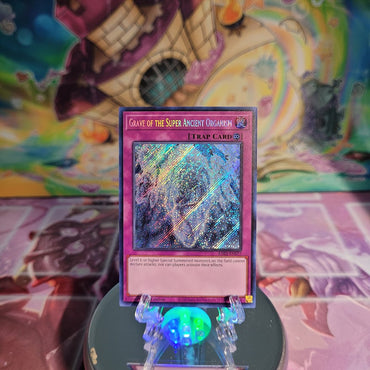 A Secret Rare "Grave of the Super Ancient Organism" card from the Yugioh Set: Quarter Century Bonanza (RA03).
