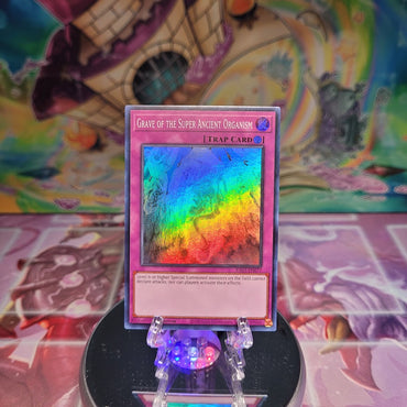 A Super Rare "Grave of the Super Ancient Organism" card from the Yugioh Set: Quarter Century Bonanza (RA03).