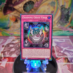 A Super Rare "Grinning Grave Virus" card from the Yugioh Structure Deck: Lair of Darkness.