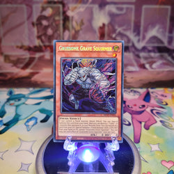 A Prismatic Secret Rare "Gruesome Grave Squirmer" card from the Yugioh 2025 Mega-Tin Mega Pack set (MP25).