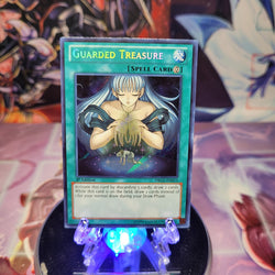 A Secret Rare "Guarded Treasure" card from the Yugioh Set: Dragons of Legend.