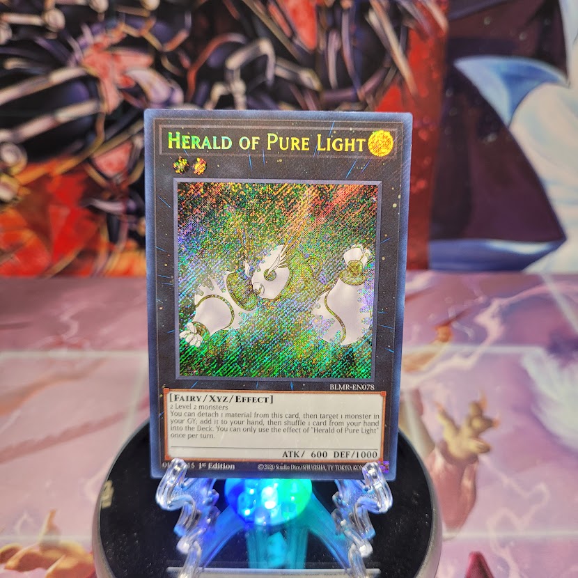 A Secret Rare "Herald of Pure Light" card from the Yugioh Set: Battles of Legend: Monstrous Revenge.