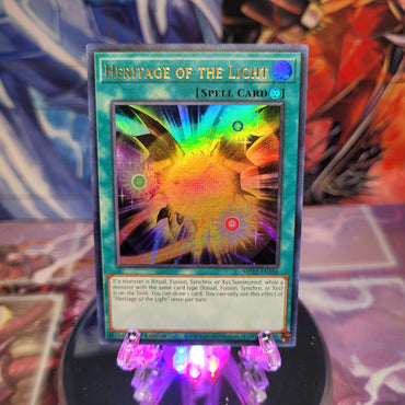 An Ultra Rare "Heritage of the Light" card from the Yugioh 2022 Tin of the Pharaoh's Gods Set (MP22).