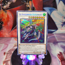 A Secret Rare "Hi-Speedroid Kitedrake" card from the Yugioh Set: Battles of Legend: Hero's Revenge.