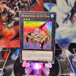 A Super Rare "Humhumming the Key Djinn" card from the Yugioh Set: World Superstars.