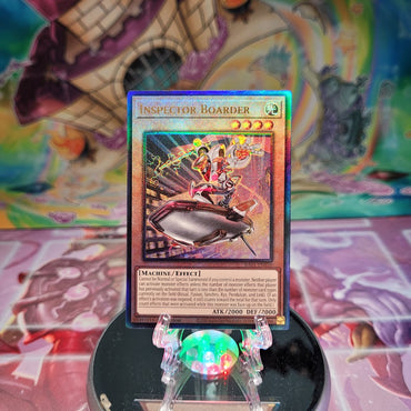 A Prismatic Ultimate Rare "Inspector Boarder" card from the Yugioh Set: Rarity Collection 1 (RA01).