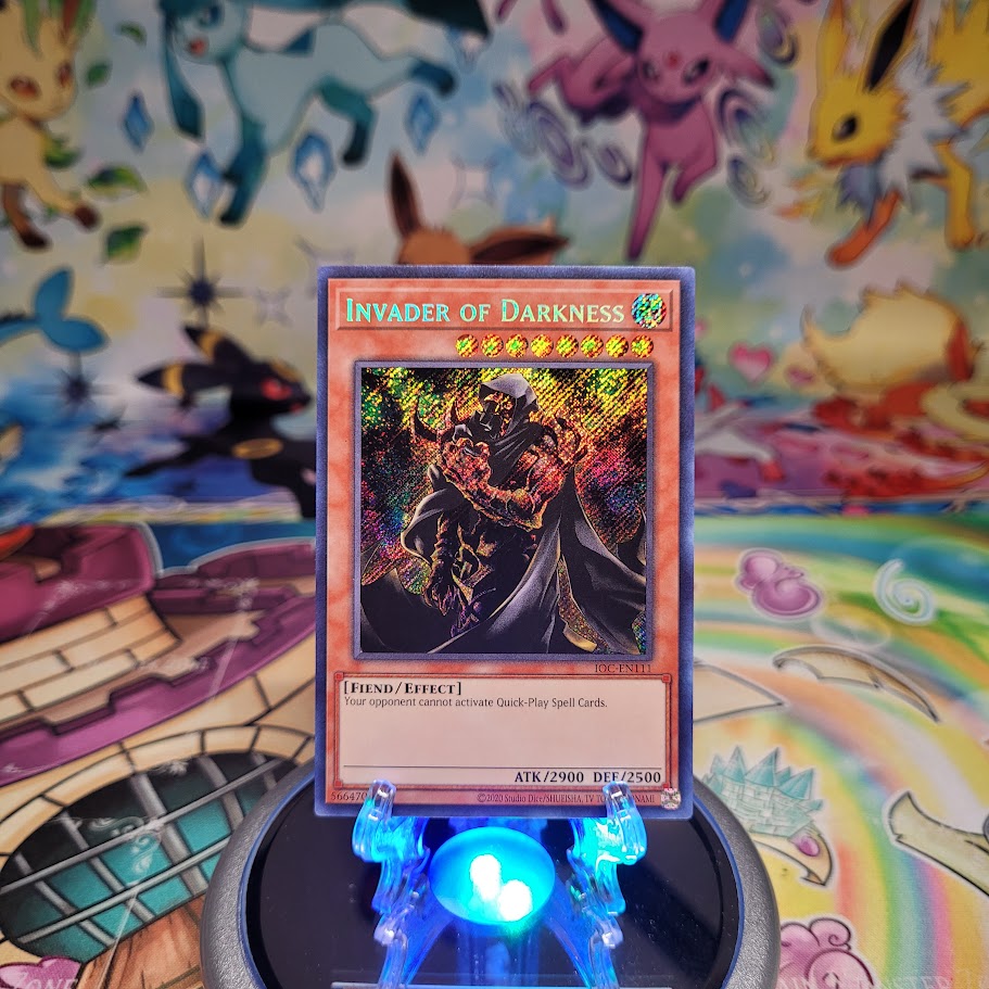 A Secret Rare "Invader of Darkness" card from the Yugioh Set: Invasion of Chaos 25th Anniversary Edition (IOC).