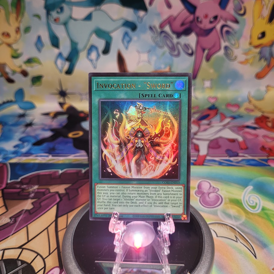 An Ultra Rare “Invocation - Sword” card from the Yugioh Set: Chaos Origins (CORI).