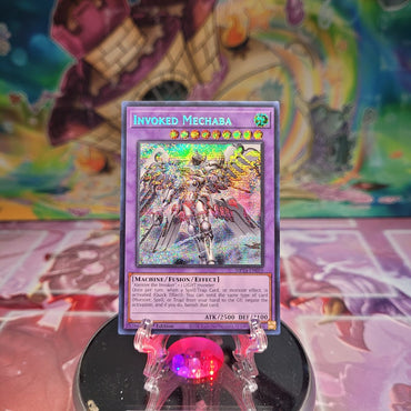 A Prismatic Secret Rare Alternate Art "Invoked Mechaba" card from the Yugioh 25th Anniversary Tin: Dueling Mirrors (MP24).