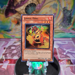 A Super Rare "Jurrac Dino" card from the Yugioh Set: Hidden Arsenal 4: Trishula's Triumph.