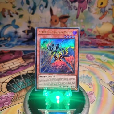 An Ultra Rare "Keeper of Dragon Magic" card from the Yugioh Structure Deck: The Fallen & The Virtuous (CH01).