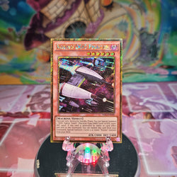 A Gold Secret Rare "Kozmo Dog Fighter" card from the Yugioh Set: Premium Gold: Infinite Gold (PGL3).