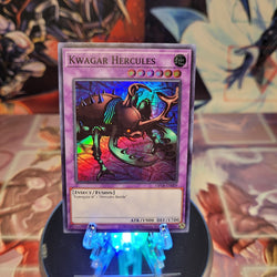 A Super Rare "Kwagar Hercules" card from the Yugioh OTS Tournament Pack 18 set.