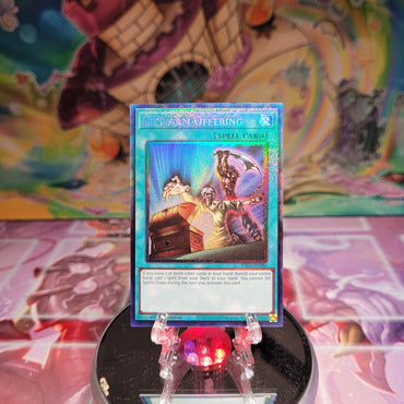 A Prismatic Collector's Rare "Left Arm Offering" card from the Yugioh Set: Quarter Century Stampede (RA04).
