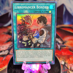  A Super Rare "Libromancer Bonded" card from the Yugioh Set: Dimension Force.