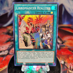  A Super Rare "Libromancer Realized" card from the Yugioh Set: Dimension Force.