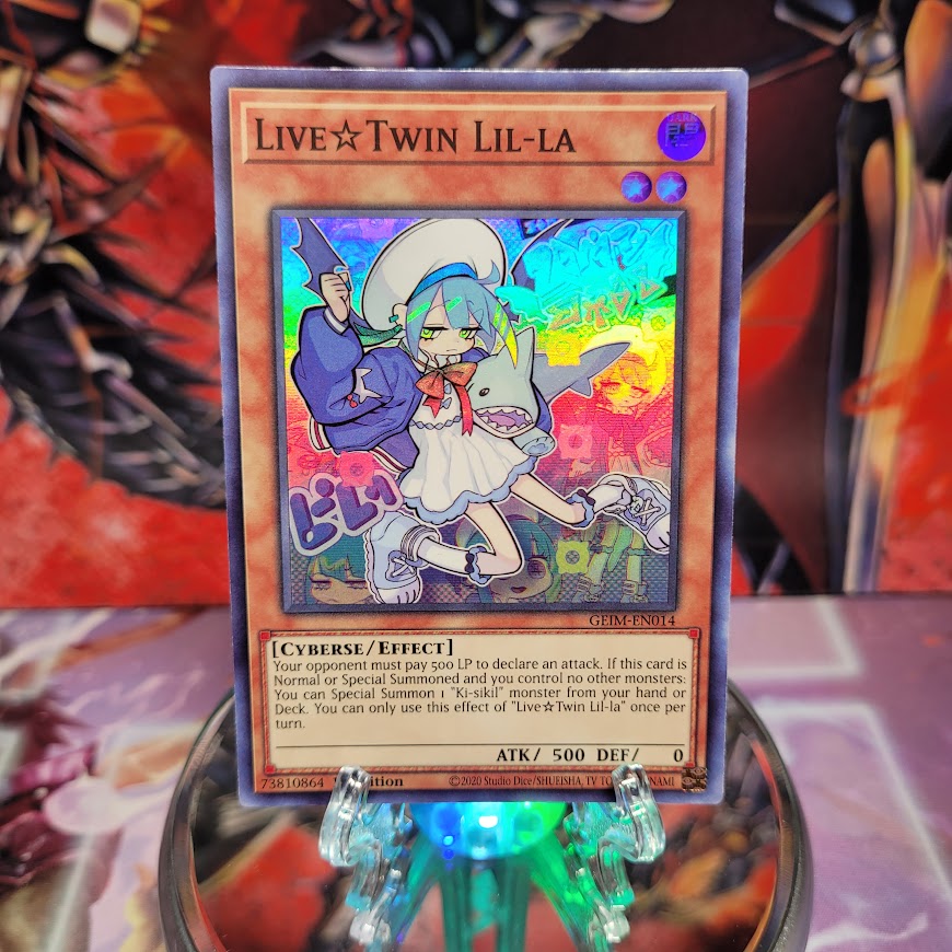 A Super Rare "Live Twin Lil-La" card from the Yugioh Set: Genesis Impact.