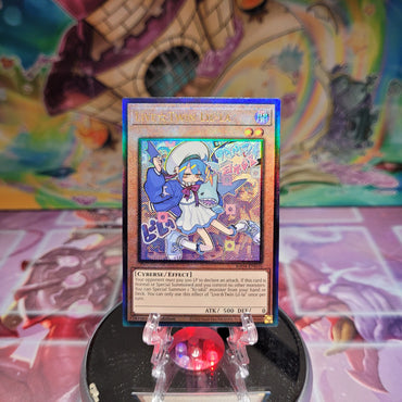 A Prismatic Ultimate Rare "Live Twin Lil-La" card from the Yugioh Set: Quarter Century Stampede (RA04).