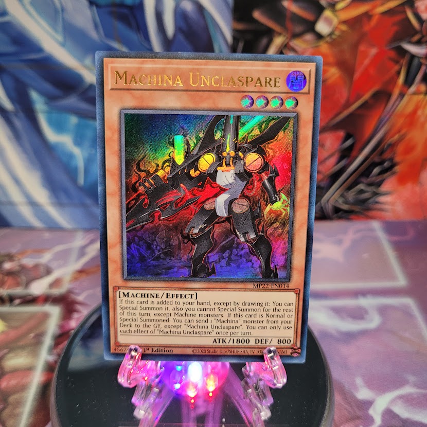 An Ultra Rare "Machina Unclaspare" card from the Yugioh 2022 Tin of the Pharaoh's Gods Set (MP22).