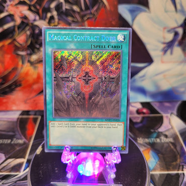 A Secret Rare "Magical Contract Door" card from the Yugioh Set: Mystic Fighters.