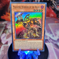  A Super Rare "Magicore Warrior of the Relics" card from the Yugioh Set: The Grand Creators (GRCR).
