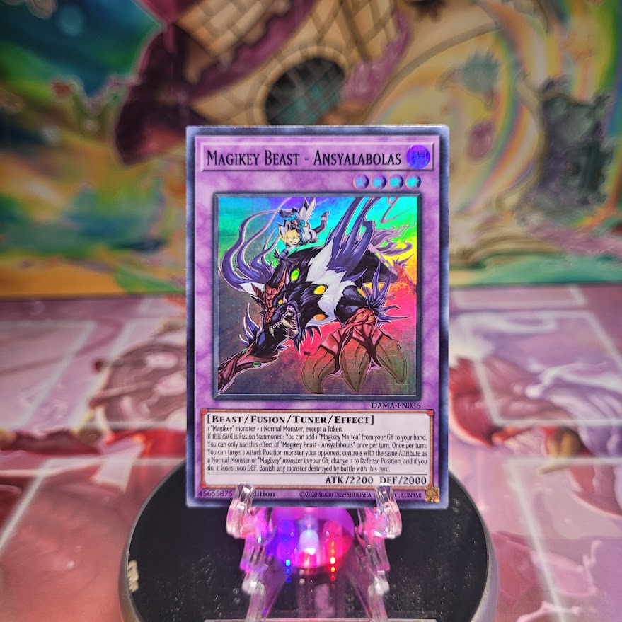 A 1st Edition Super Rare "Magikey Beast - Ansyalabolas" card from the Yugioh Set: Dawn of Majesty.