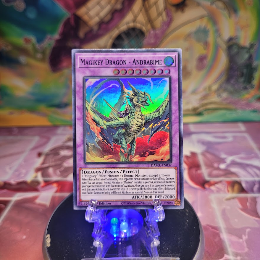 A 1st Edition Super Rare "Magikey Dragon - Andrabime" card from the Yugioh Set: Dawn of Majesty