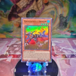 An Ultra Rare "Magnarokket Dragon" card from the Yugioh 2018 Mega-Tins. 