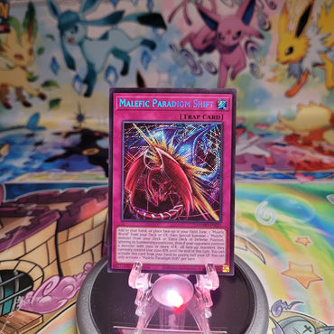 A Secret Rare "Malefic Paradigm Shift" card from the Yugioh Set: Magnificent Monsters (MAMO).