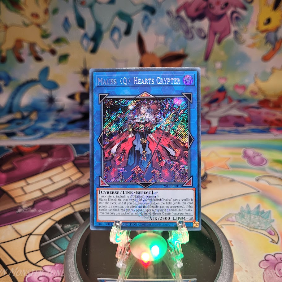 An Emblazoned Secret Rare "Maliss Q Hearts Crypter" card from the Yugioh Set: Limited Pack World Championship 2025 (25LP).