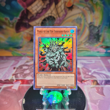 A Super Rare "Manju of the Ten Thousand Hands" card from the Yugioh Set: Hidden Summoners.