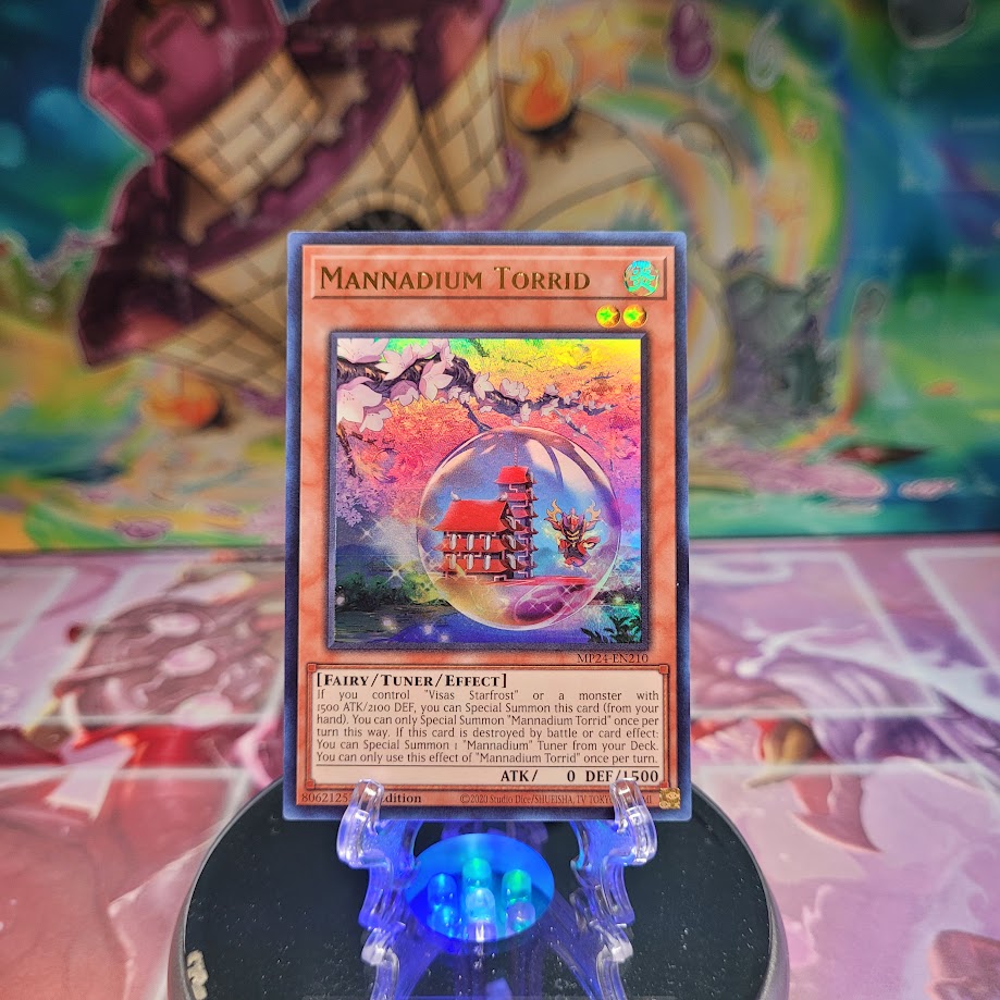 An Ultra Rare "Mannadium Torrid" card from the Yugioh Set: 25th Anniversary Tin: Dueling Mirrors.