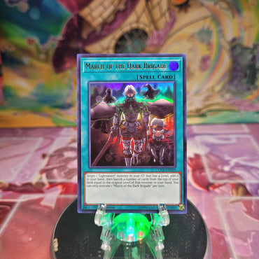 A 1st edition Ultra Rare "March of the Dark Brigade" card from the Yugioh Set: Code of the Duelist.