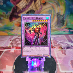 A Super Rare "Masked Hero Acid" card from the Yugioh Set: Toon Chaos (TOCH).