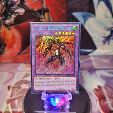 A Secret Rare "Masked Hero Dark Law" card from the Yugioh Set: Rarity Collection 1 (RA01).