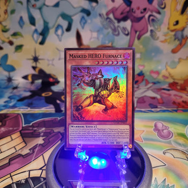 A Super Rare "Masked Hero Furnace" card from the Yugioh Set: Maze of Muertos (MZMU).
