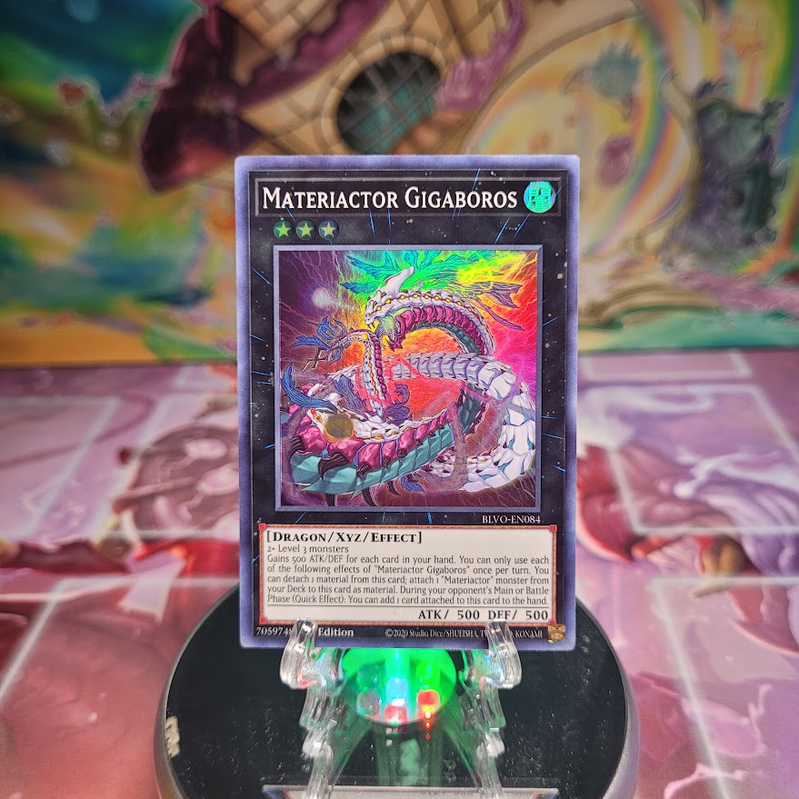 A 1st Edition Super Rare "Materiactor Gigaboros" card from the Yugioh Set: Blazing Vortex.