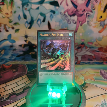 An Ultra Rare "Mayhem Fur Hire" card from the Yugioh Set: Battles of Legend: Glorious Gallery (BLGG).