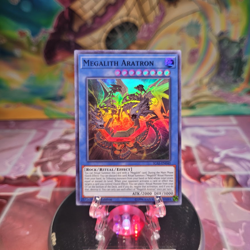 A Super Rare "Megalith Aratron" card from the Yugioh Set: Ignition Assault.