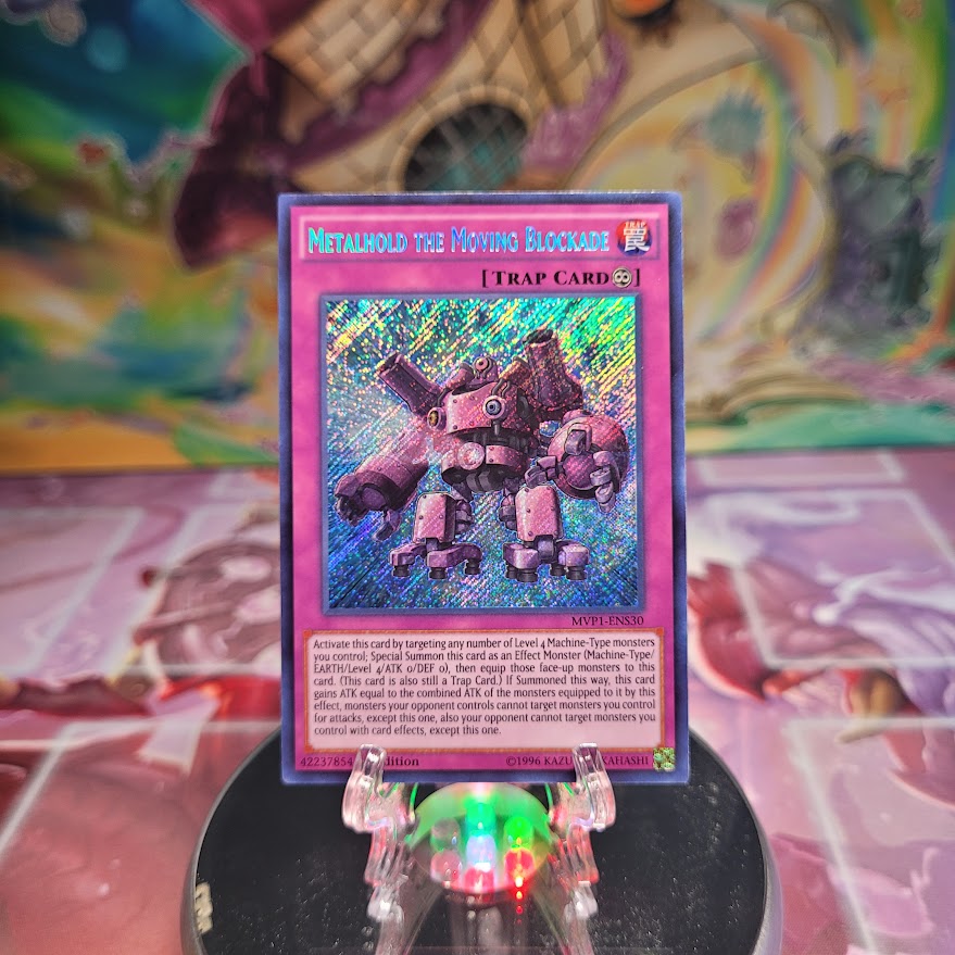 A 1st edition Secret Rare "Metalhold the Moving Blockade" card from the Yugioh Set: The Dark Side of Dimensions: Movie Pack Secret Edition.