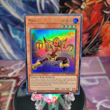 An Ultra Rare "Mimicking Man-Eater Bug" card from the Yugioh 2022 Tin of the Pharaoh's Gods Set (MP22).