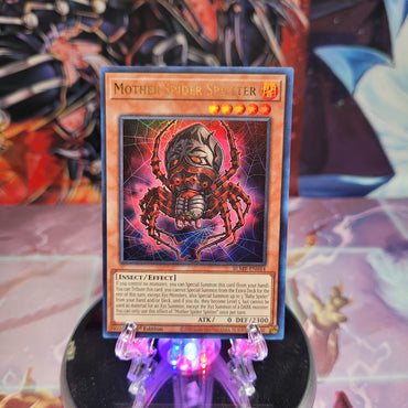 An Ultra Rare "Mother Spider Splitter" card from the Yugioh Set: Battles of Legend: Monstrous Revenge.