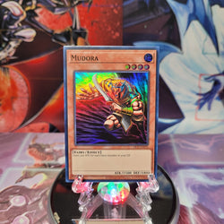 A Super Rare 25th Anniversary "Mudora" card from the Yugioh Set: Dark Crisis 