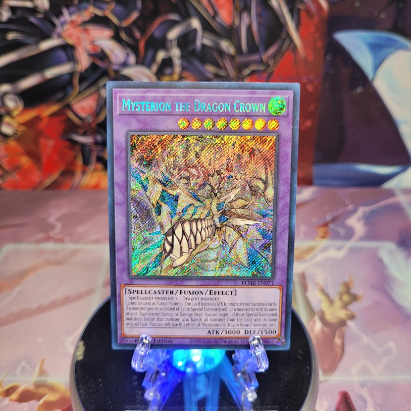 A Secret Rare "Mysterion the Dragon Crown" card from the Yugioh Set: Battles of Legend: Monstrous Revenge (BLMR).